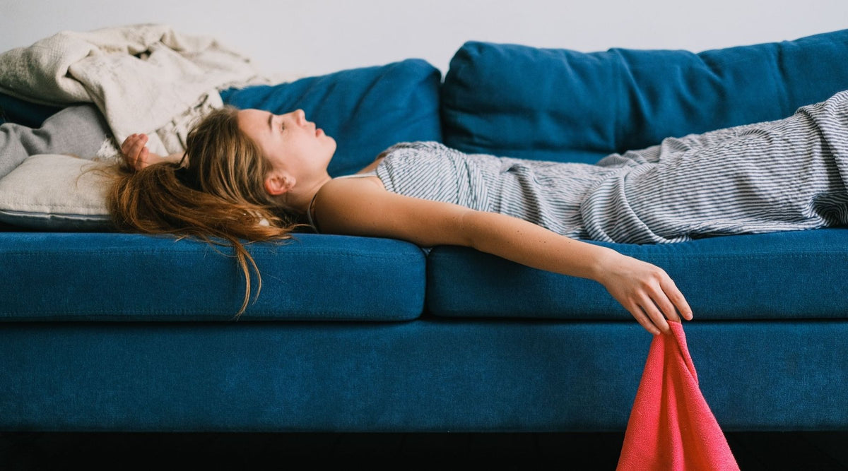 woman lying on sofa, exhausted