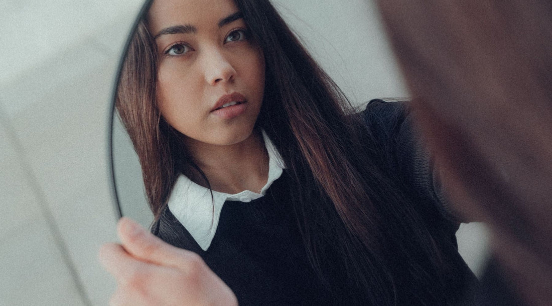 woman looking in mirror