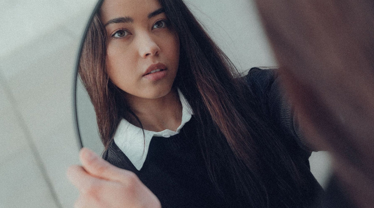 woman looking in mirror