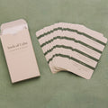 Set of 'Seeds of Calm' cards with a beige envelope on a green textured background