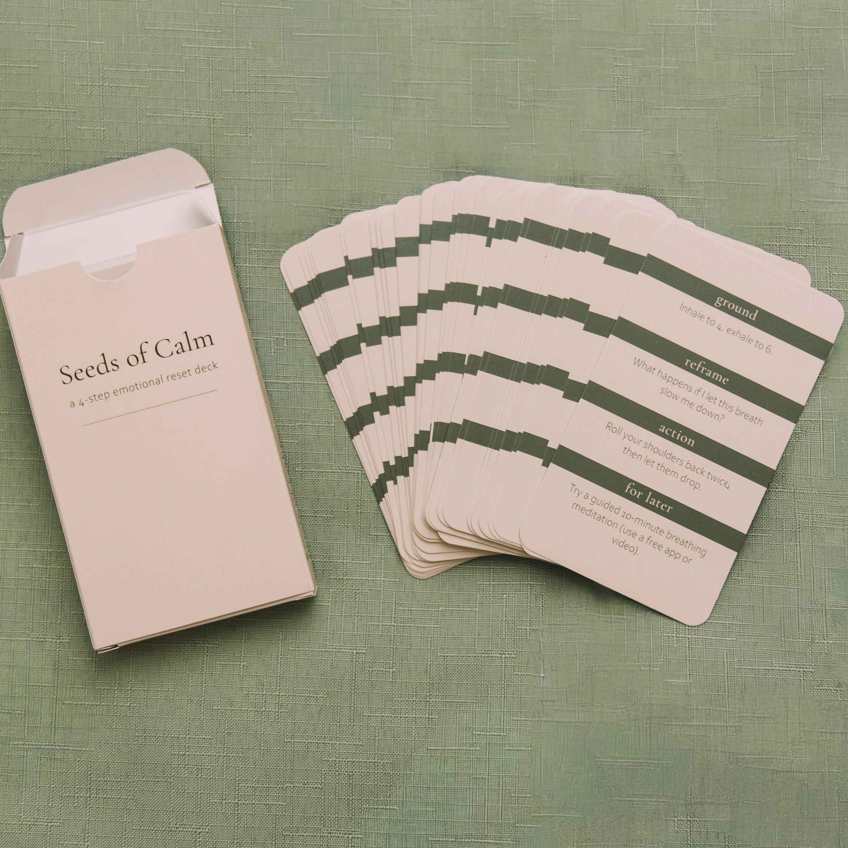 Set of 'Seeds of Calm' cards with a beige envelope on a green textured background